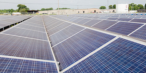 A large array of solar panels in a field.