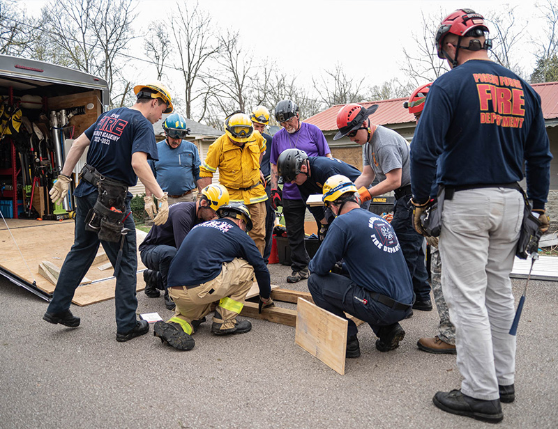 A group of first responders participate in structural collapse training activity.